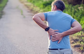 A man holding on to his aching spine