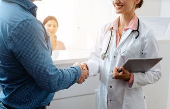 Doctor shaking hands with a patient.